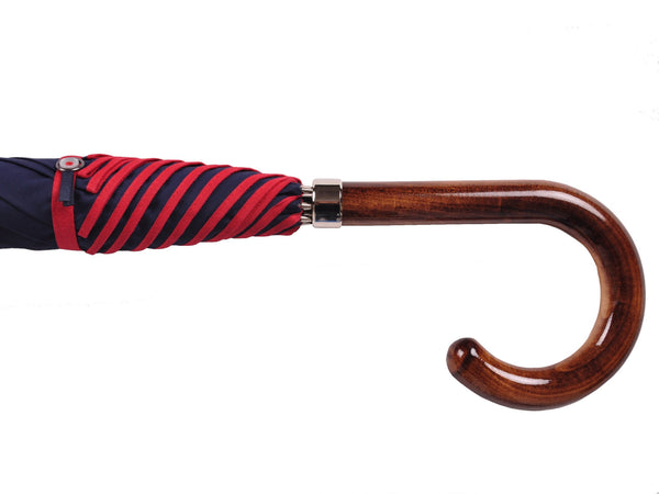 Poly Cotton canopy with contrast binding. Black metal tube frame. Nickel finishes. Scorched Maple handle. Available in Ivory/Yellow, Navy/Red, Black/Blue.
